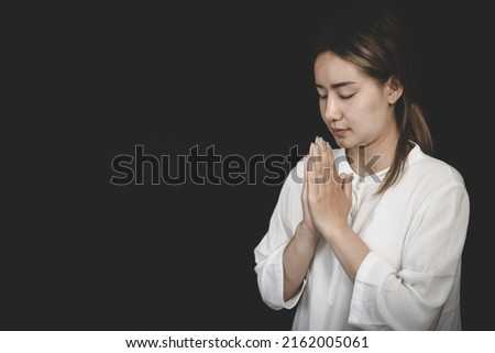 A woman folded her hands, praying for blessings and praying to God. Praying for spiritual beliefs. The power of hope or love and loyalty. Faith in goodness.