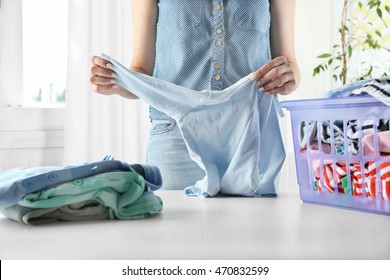 Woman Folding Clothes In Laundry