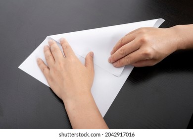 A Woman Is Folding Paper.