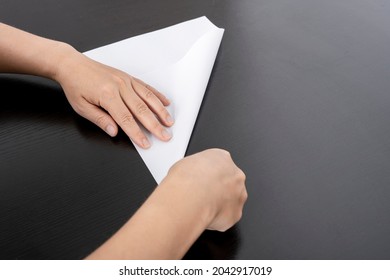 A Woman Is Folding Paper.