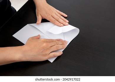 A Woman Is Folding Paper.