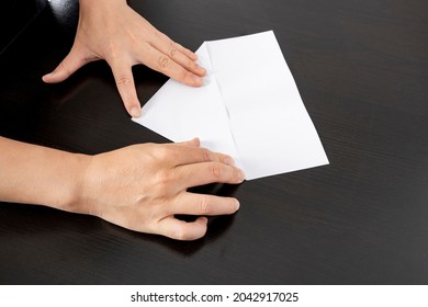 A Woman Is Folding Paper.