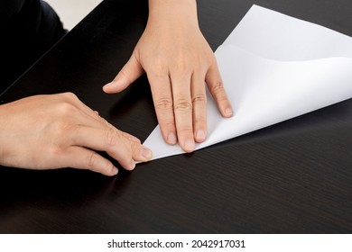 A Woman Is Folding Paper.