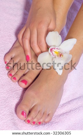 woman foot with orchid
