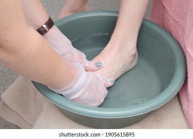 Woman Foot Treatment In Paraffin Bath At The Spa.