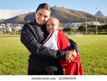 Woman Football Coach, Girl Soccer Player Hug On Home Field And Celebrate Child Sports Game Win. Teamwork, Athletic Fitness And Tactical Strategy With Passion Or Motivation Lead To Winning Competition