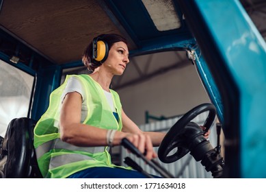 Woman forklift operator driving vehicle