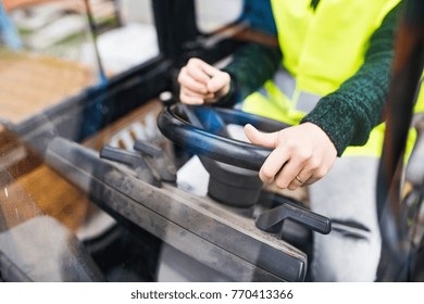 Woman Forklift Truck Driver In An Industrial Area.