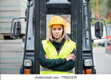 Woman Forklift Truck Driver In An Industrial Area.