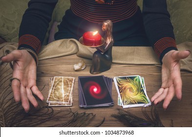 Woman fortune-teller chooses a deck of cards for divination.