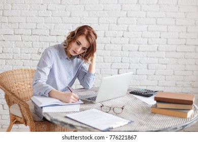 Woman freelancer female hands with pen writing on notebook at home or office