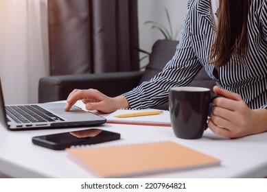 Woman Freelancer Working On Laptop At Home-office. Startup Concept. Close Up Of Female Hands Working Computer Typing On Keyboard And Hold Cup Coffee. Businesswoman Writing Business Letter At Work