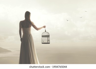 woman frees a bird from its cage and watches it fly away in the sky with other birds 