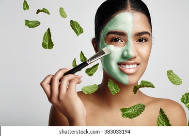 Woman With A Fresh Green Mask With Avocado And Mint Leavs In Air