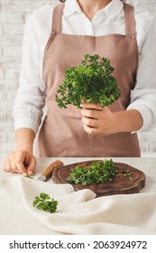 Woman With Fresh Parsley At Table