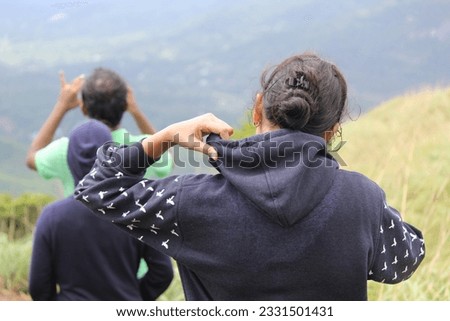 woman with friends hiking and trekking at wayanad chembra peak mountain hills