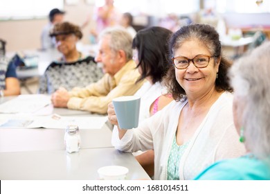 Woman With Friends Talking And Having Coffee In A Senior Center