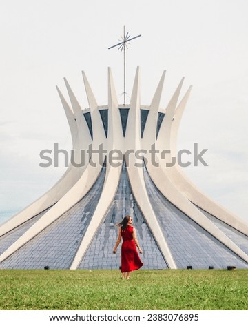 woman in front of cathedral in brasilia, by oscar niemeyer