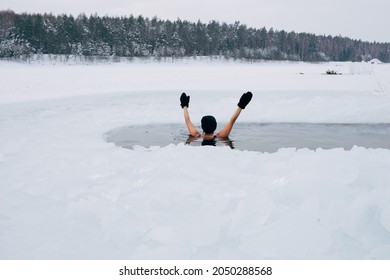 Woman In Frozen Lake Ice Hole. Winter Cold Swimming. Swimmers Wellness In Icy Water. How To Swim In Cold Water. Beautiful Young Female In Zen Meditation. Hat And Gloves Swimming Clothes. Nature Lake