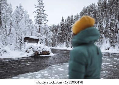 Woman At A Frozen River In Lapland, Finland