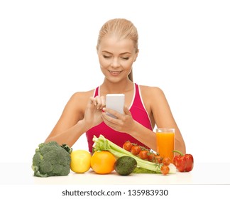 Woman With Fruits And Vegetables Counting Calories On Smartphone