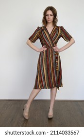 Woman In Funky Multicolor Striped Wrap Midi Dress. Studio Shot.