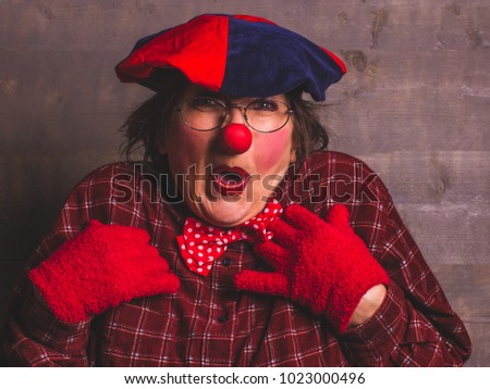 Woman funny clown with red nose and gloves.