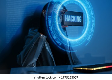 Woman with futuristic tablet in hand. Internet, crime, cyber attack, system breaking concept. Blue neon light background. Hacker using an abstract smartphone with a binary code digital interface.