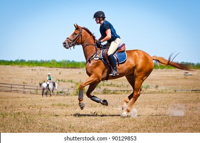 Woman Galloping Horse On A Cross Country Course