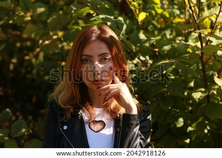 Similar – Young redhead woman surrounded by plants