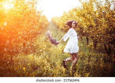 Woman In The Garden With A Wreath On His Head At Sunset