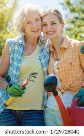 Woman Gardening Together In Summer Looking At Each Other