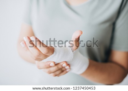 Woman with gauze bandage wrapped around her hand