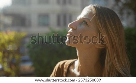 Similar – Image, Stock Photo Young woman gazing upwards in urban setting