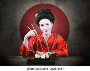 Woman In Geisha Makeup Eating Sushi