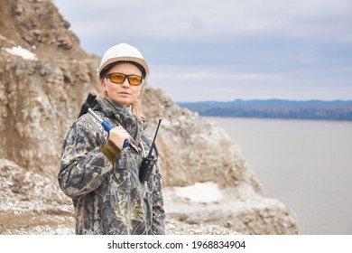 Woman Geologist On The Background Of The Open Pit On The Edge Of A Mountain