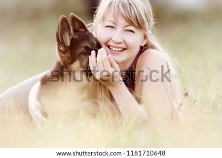 Similar – Pretty blond woman with her two dogs