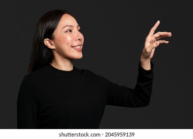 Woman gesture pressing on an invisible screen - Powered by Shutterstock