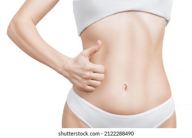 Woman with gesture thumb up in front of her belly. thumbs up in front of the stomach.  Healthy woman with a fit body showing thumb up in front of her slim abdomen as a gesture of good stomach health. 