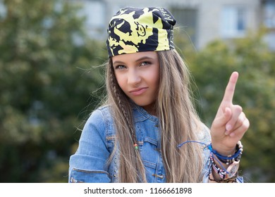 Woman Gesturing A No Sign. Closeup Portrait Unhappy Serious Negative Hipster Girl With Bandana Raising Finger Up Saying Oh No You Did Not Do That Green Outdoors Background Lady With Blondish Long Hair