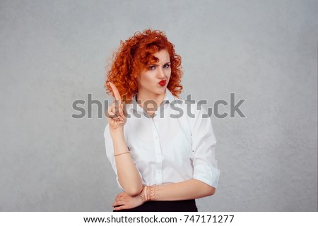 woman gesturing a no sign. portrait unhappy, serious redhead curly retro style girl raising finger up saying oh no you did not do that gray grey background. Negative emotions facial expression feeling