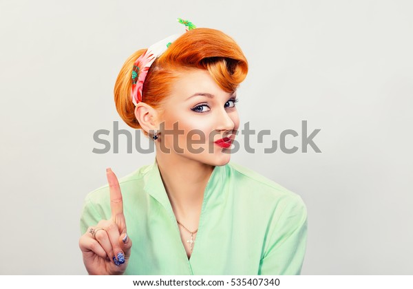woman gesturing a no sign. portrait unhappy,\
serious pinup retro style girl raising finger up saying oh no you\
did not do that white grey background. Negative emotions, facial\
expressions, feelings