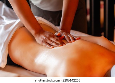 Woman gets body massage in spa salon. Healthy lifestyle and body care concept. Female person on massage table gets therapy in luxury spa salon. Masseur make medical massage for client - Shutterstock ID 2206142253