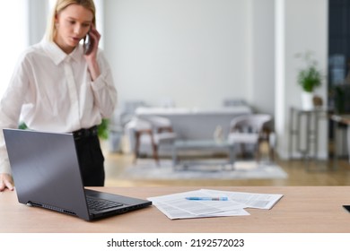 Woman Gets Up From Her Desk And Talks On Phone