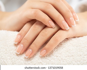 Woman gets manicure procedure in a spa salon. Beautiful female hands. Hand care. Woman cares for the nails on hands. Beauty treatment with skin of hand.   Woman's hands close-up view.