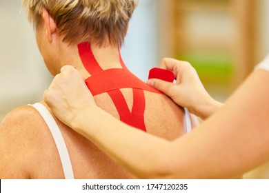 Woman Gets A Red Kinesio Tape In Her Neck For Pain Relief In Cervical Syndrome