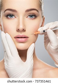Woman getting cosmetic injection of botox in cheek, closeup. Woman in beauty salon. plastic surgery clinic.