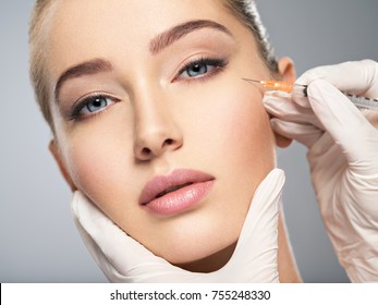 Woman Getting Cosmetic Injection Of Botox In Cheek, Closeup. Woman In Beauty Salon. Plastic Surgery Clinic.