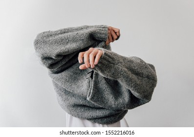 Woman Getting Dressed In A Wool Sweater