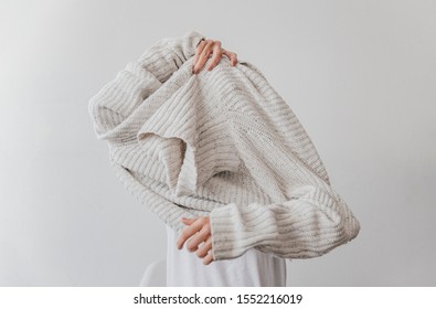 Woman Getting Dressed In A Wool Sweater